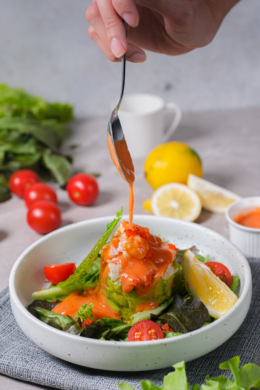 salad with tomatoes and lemon topped with sauce